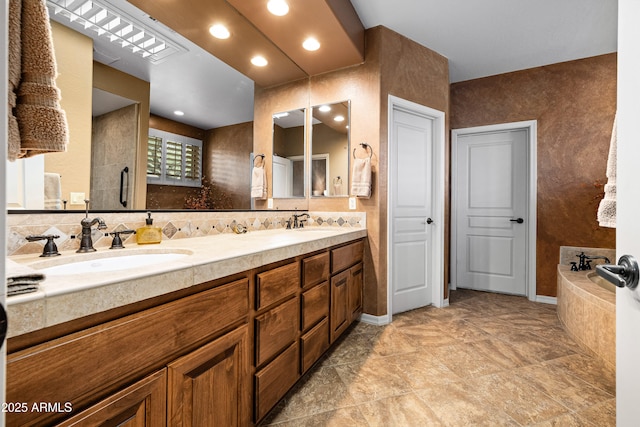 full bath with double vanity, a shower with shower door, a sink, and a bathing tub