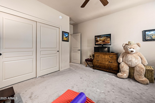 interior space featuring carpet floors, a closet, and a ceiling fan