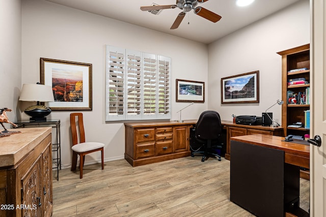 home office featuring light wood-type flooring, baseboards, and a ceiling fan