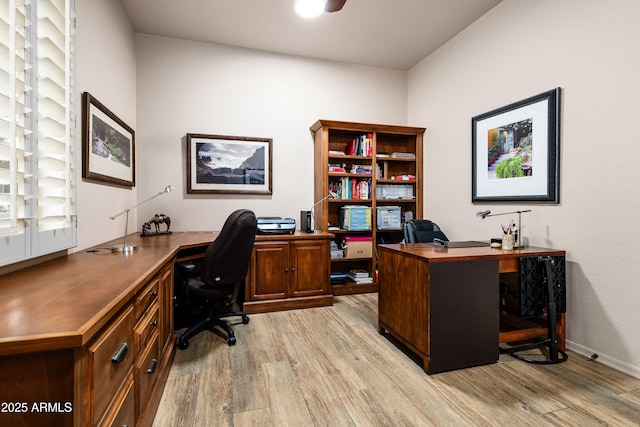 home office featuring light wood finished floors and baseboards