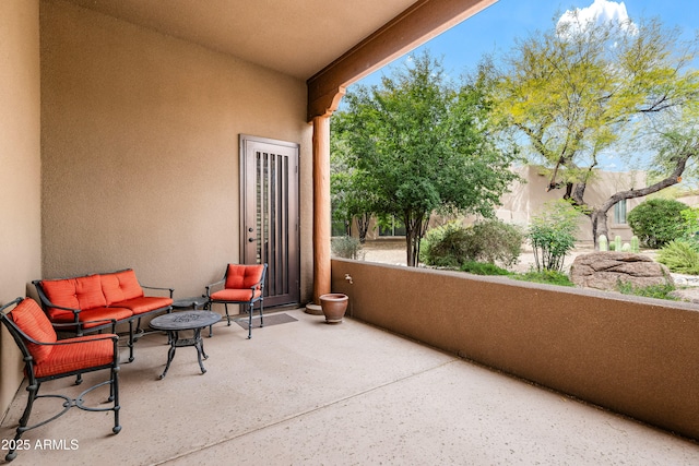 view of patio featuring a balcony