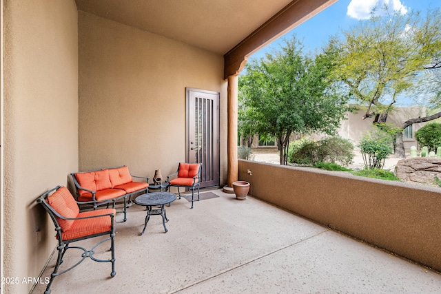 view of patio featuring a balcony