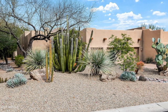 exterior space featuring fence and stucco siding