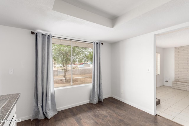 3042 N 87th Ave, Phoenix, AZ 85037 - empty room featuring wood finished floors and a tray ceiling