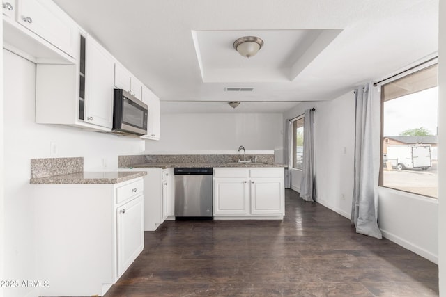 3042 N 87th Ave, Phoenix, AZ 85037 - kitchen featuring stainless steel appliances, a raised ceiling, white cabinets, a peninsula, and a sink