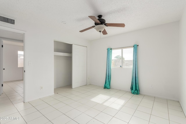 3042 N 87th Ave, Phoenix, AZ 85037 - unfurnished bedroom featuring a closet, a textured ceiling, and a ceiling fan