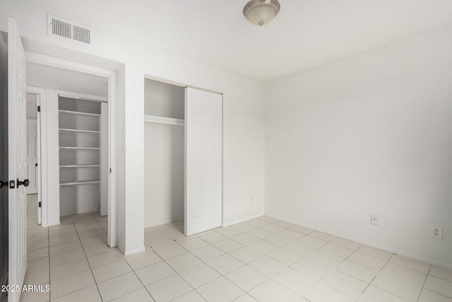 3042 N 87th Ave, Phoenix, AZ 85037 - unfurnished bedroom featuring a closet and light tile patterned flooring