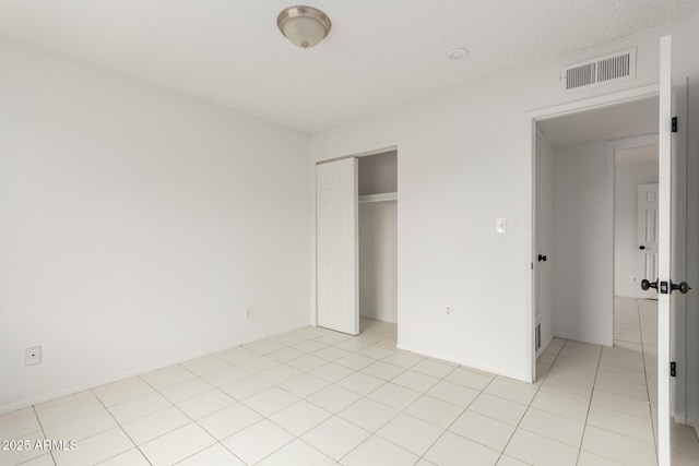 3042 N 87th Ave, Phoenix, AZ 85037 - unfurnished bedroom featuring a closet and light tile patterned floors