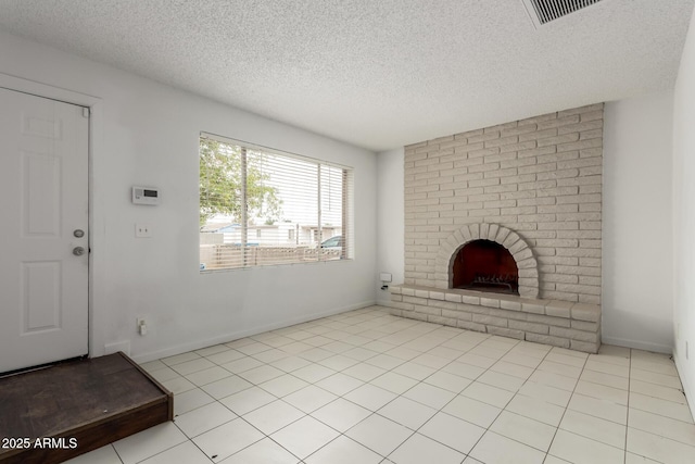 3042 N 87th Ave, Phoenix, AZ 85037 - unfurnished living room featuring a textured ceiling, a brick fireplace, tile patterned flooring, and baseboards