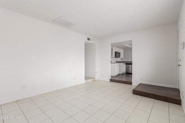 3042 N 87th Ave, Phoenix, AZ 85037 - spare room featuring light tile patterned floors