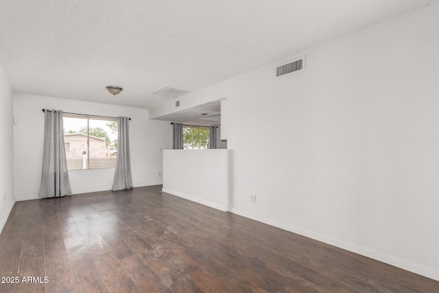 3042 N 87th Ave, Phoenix, AZ 85037 - empty room featuring wood finished floors, a textured ceiling, and baseboards