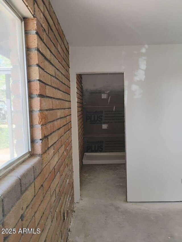 2435 E 13th St, Douglas, AZ 85607 - hallway with brick wall and concrete floors