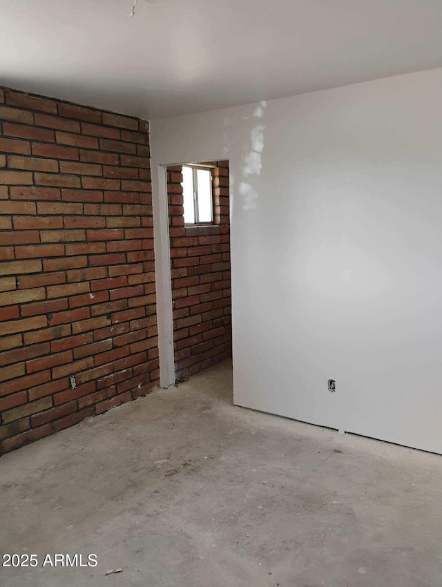 2435 E 13th St, Douglas, AZ 85607 - spare room featuring brick wall and concrete flooring