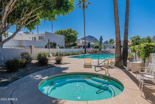 view of swimming pool featuring a patio and a community hot tub