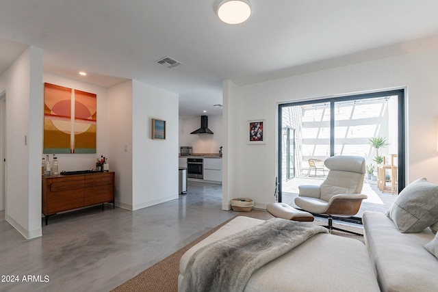 bedroom featuring concrete flooring and access to exterior