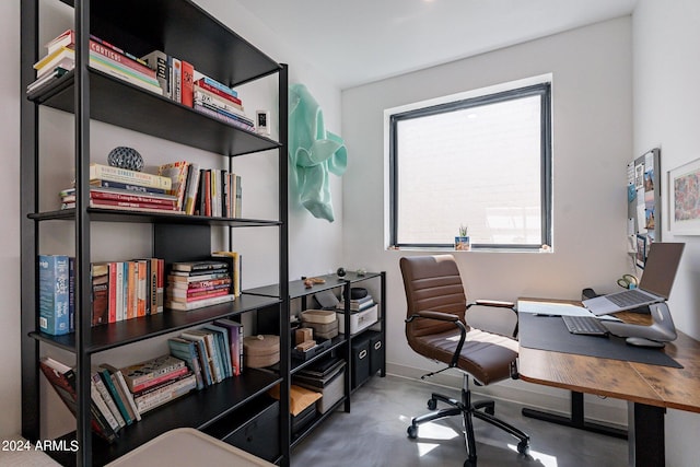 home office with concrete flooring