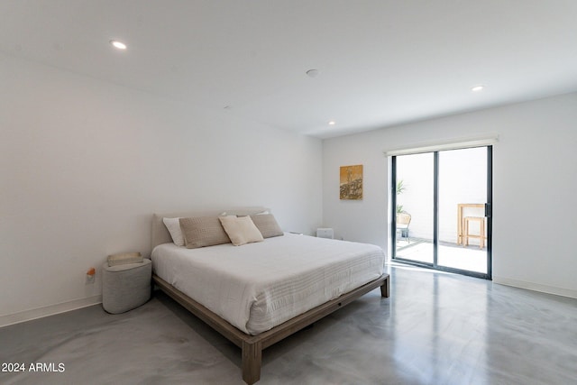 bedroom with access to outside and concrete floors