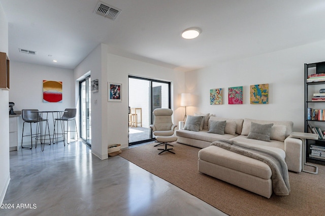 living room with concrete flooring