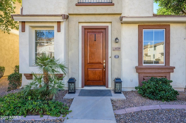 doorway to property with stucco siding