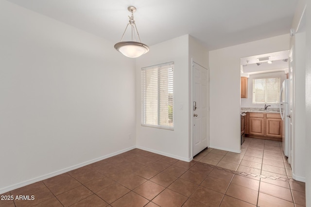 1825 W Ray Rd Unit 1070, Chandler, AZ 85224 - unfurnished dining area with light tile patterned floors, a sink, and baseboards