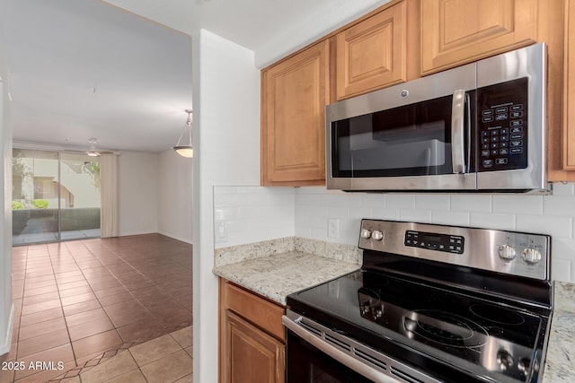 1825 W Ray Rd Unit 1070, Chandler, AZ 85224 - kitchen with appliances with stainless steel finishes, tasteful backsplash, light tile patterned floors, and light stone counters