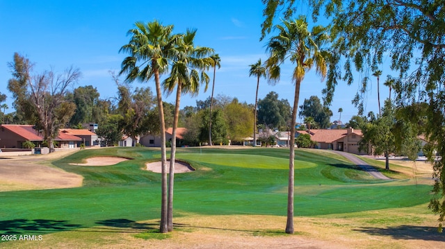 surrounding community with a lawn and golf course view