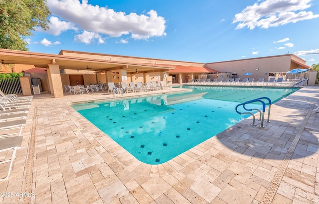 community pool with a ceiling fan, a patio, and fence