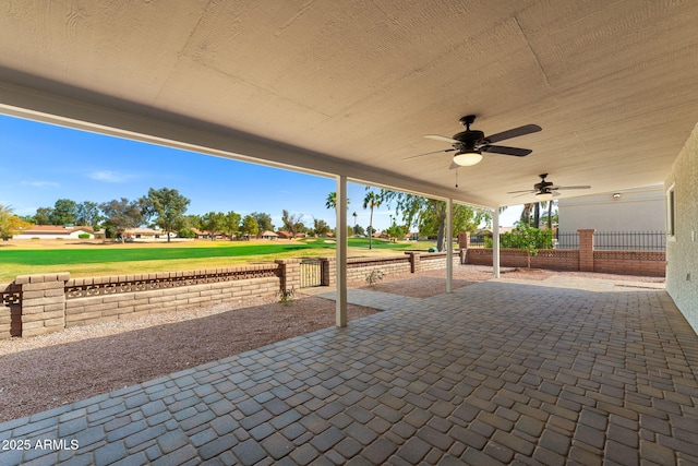 view of patio / terrace with fence and ceiling fan