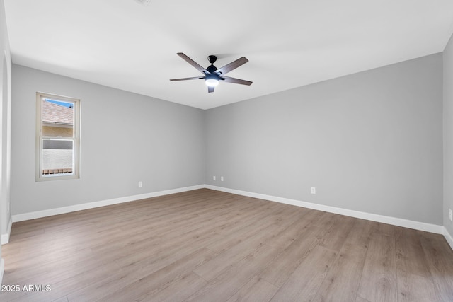 empty room with wood finished floors, baseboards, and ceiling fan