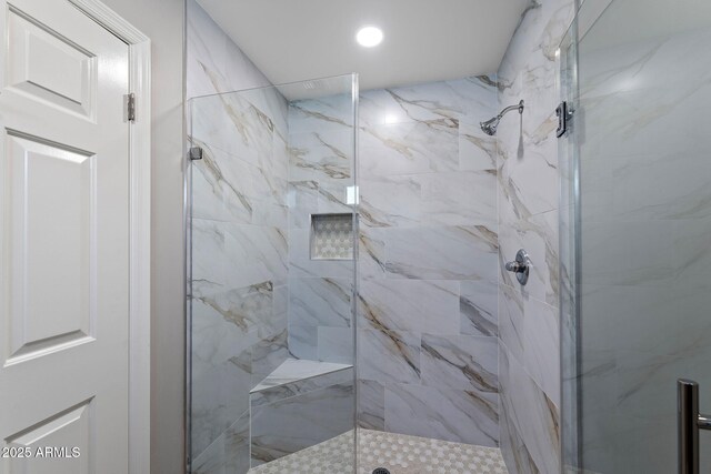 full bath featuring a marble finish shower