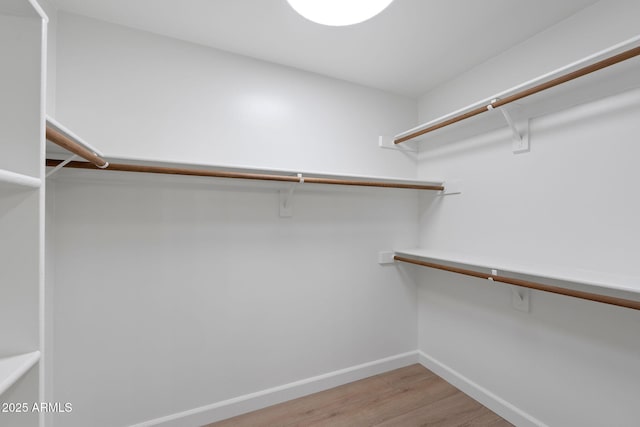 spacious closet with light wood-style flooring