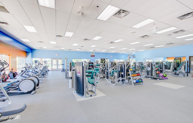 exercise room featuring a paneled ceiling and visible vents