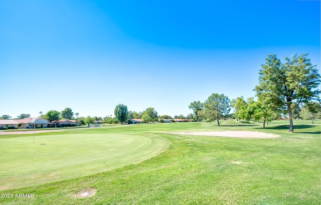 view of home's community featuring a yard and golf course view