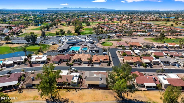 drone / aerial view featuring a residential view, golf course view, and a water and mountain view