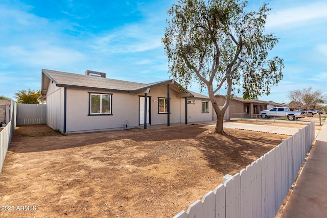 ranch-style house with a fenced backyard