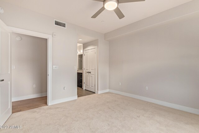 unfurnished bedroom with carpet floors and ceiling fan