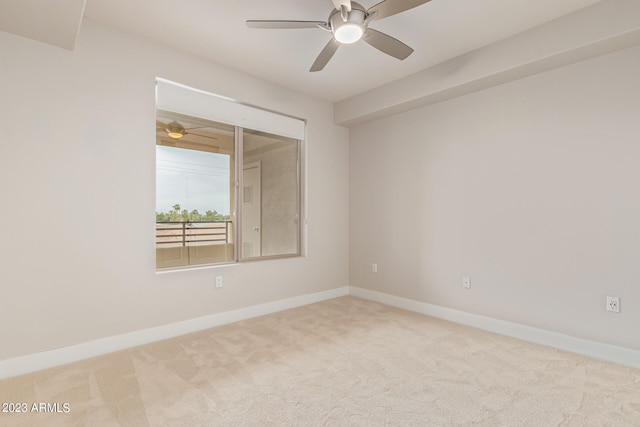 unfurnished room with light colored carpet and ceiling fan