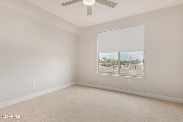 spare room featuring carpet flooring, a ceiling fan, and baseboards