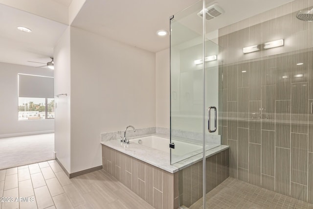 bathroom with a stall shower, a bath, ceiling fan, recessed lighting, and baseboards