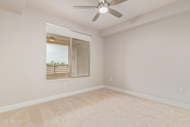 unfurnished room with carpet floors, a ceiling fan, and baseboards