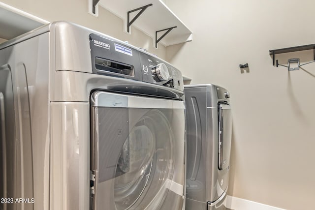 clothes washing area featuring washing machine and clothes dryer