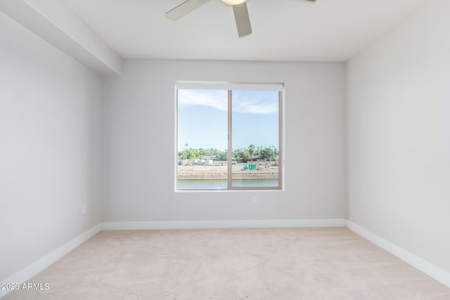 unfurnished room with ceiling fan and light colored carpet