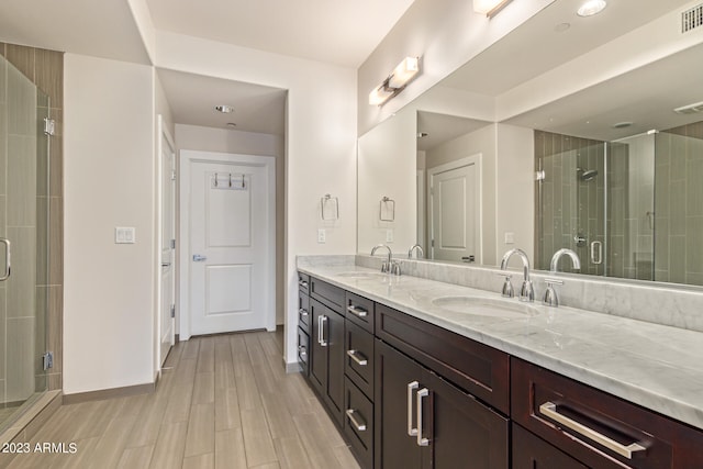 bathroom with vanity and a shower with shower door