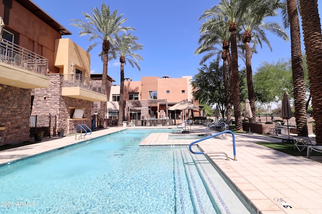 view of swimming pool with a patio area