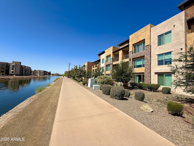 view of property's community featuring a residential view and a water view