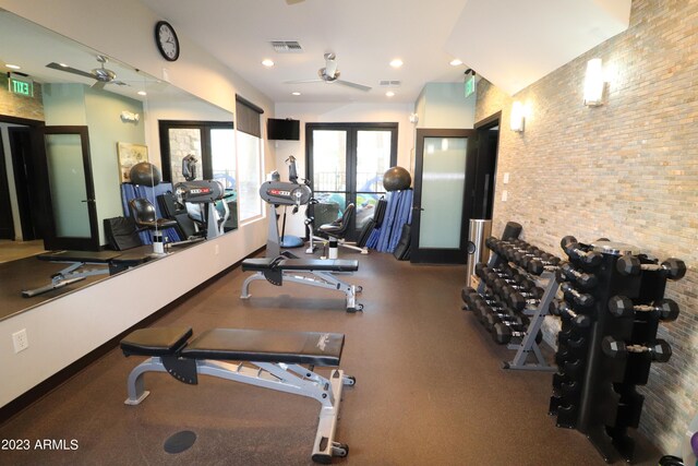 exercise room featuring french doors, brick wall, and ceiling fan