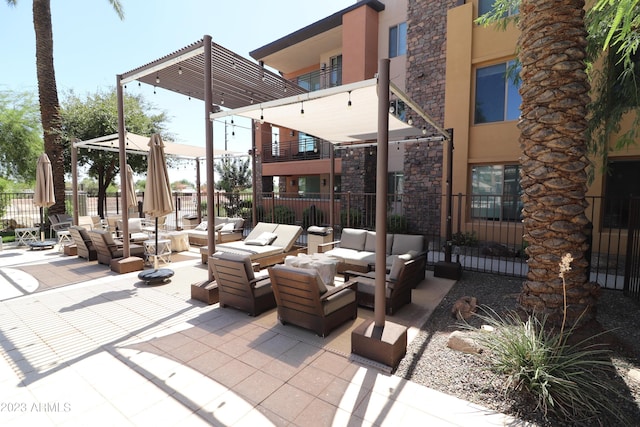 view of patio / terrace featuring an outdoor living space and fence