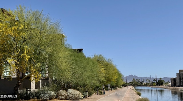 view of community with a water and mountain view