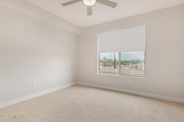 empty room with light colored carpet and ceiling fan