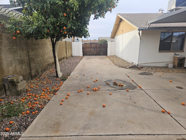 view of patio with fence and a gate